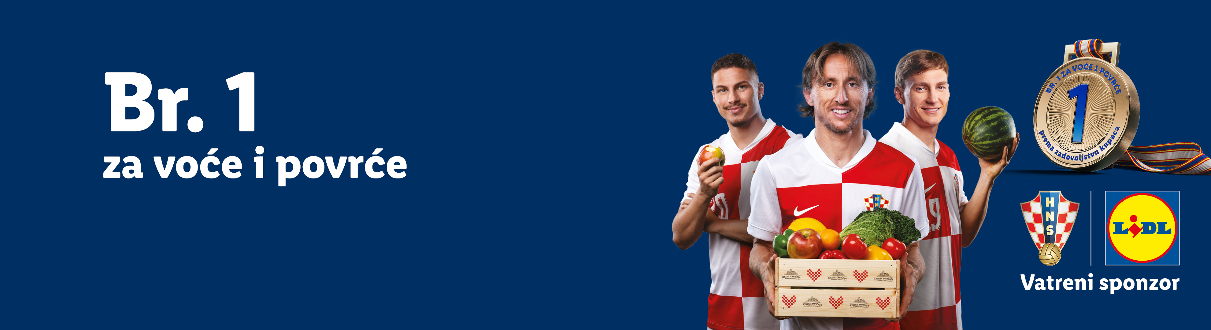 Nogometaši s košarom voća i povrća, medaljom i tekstom: Br. 1 za voće i povrće.